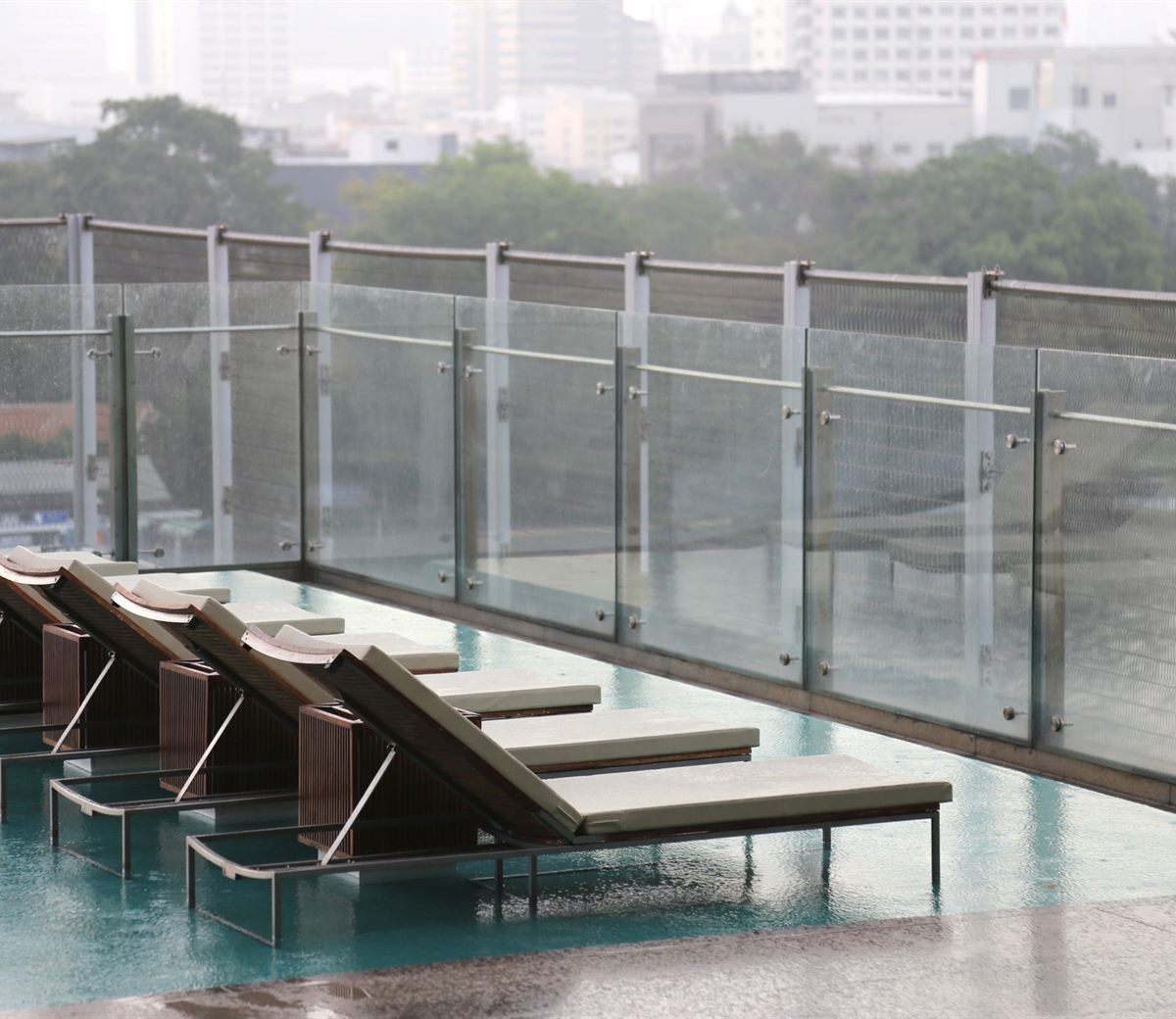 Frameless glass fencing around a pool